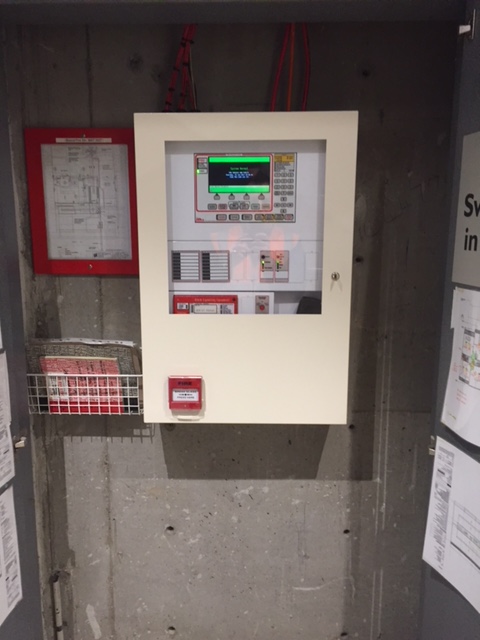Wall-mounted fire indicator panel on concrete